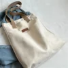 women’s advanced sense canvas tote bag with sewing thread details